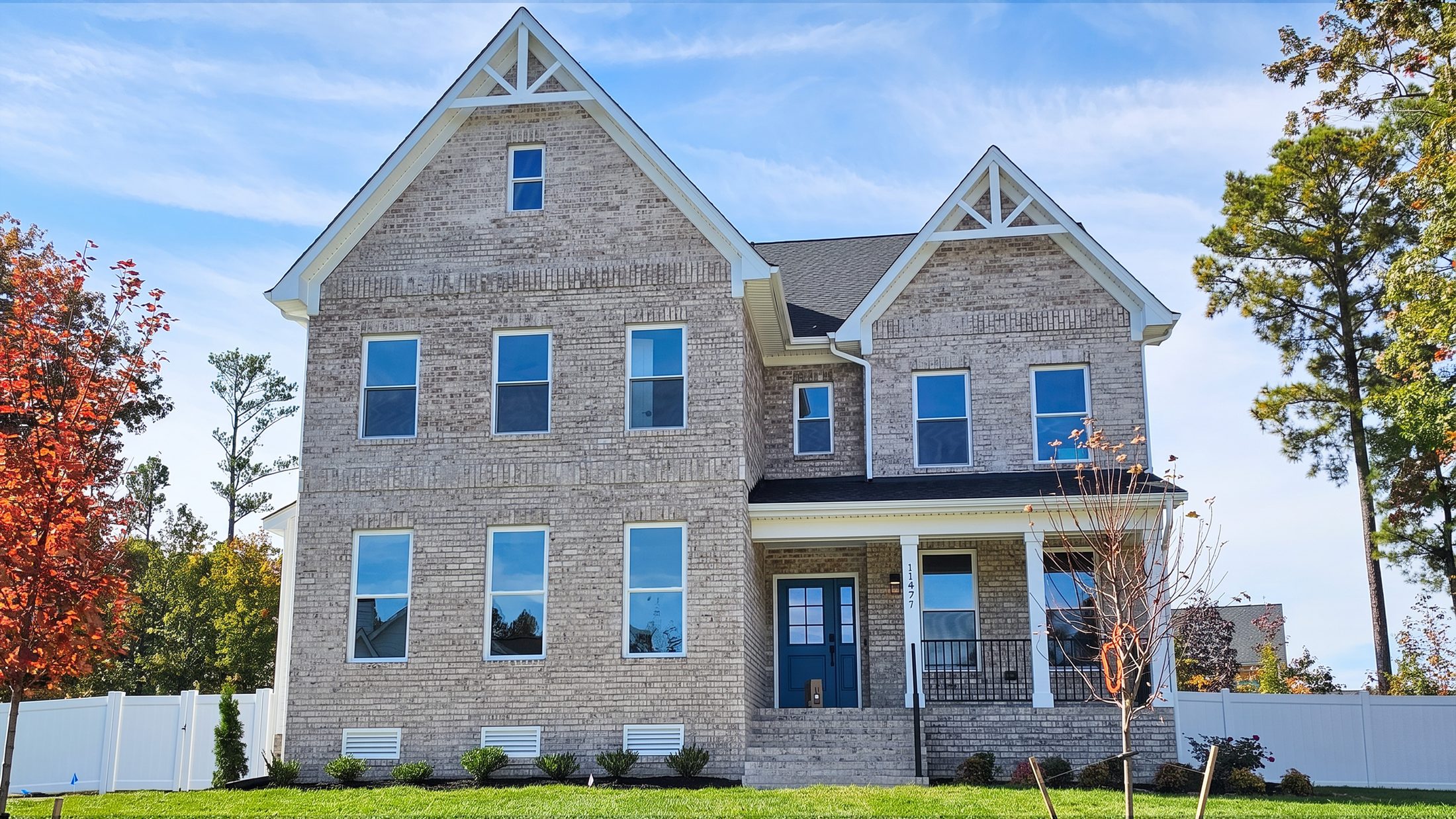 The Castle Rock — a pale brick home with tall gables and deep-set windows
